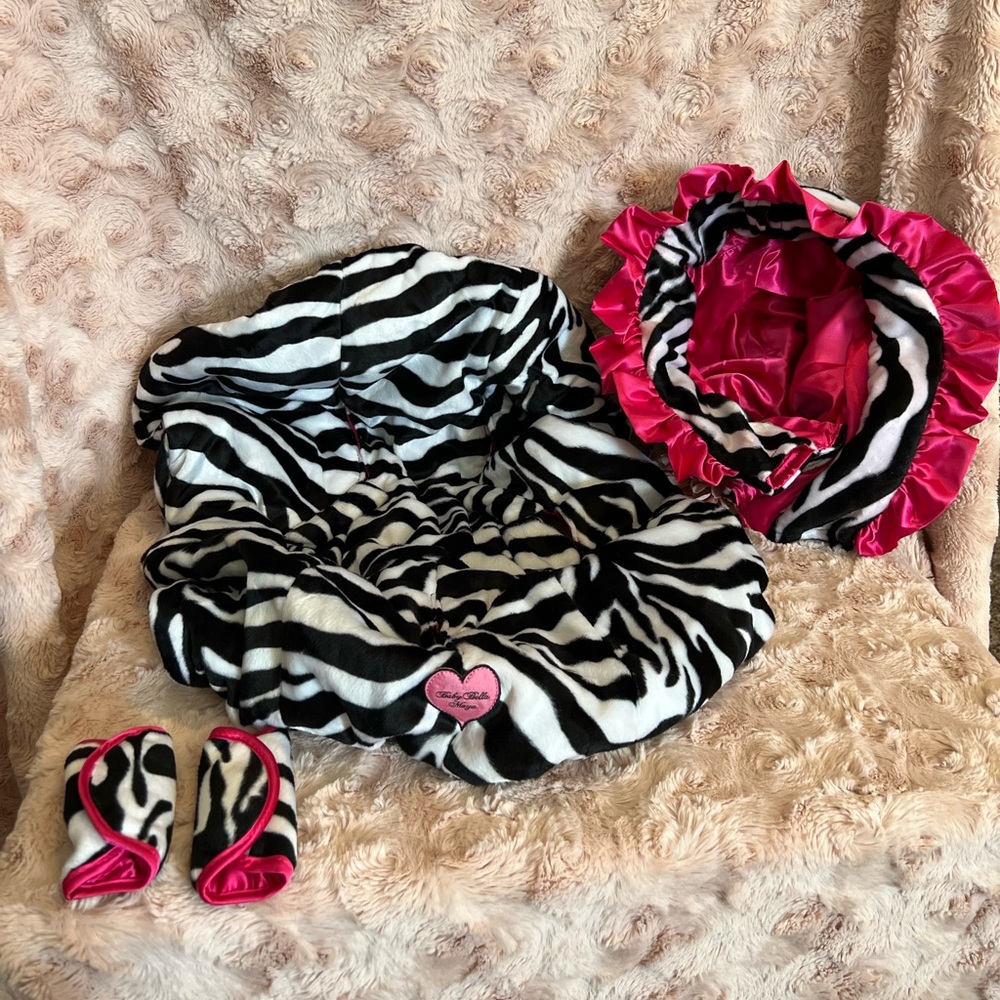 Baby Bella Maya infant car seat cover in zebra and hot pink.